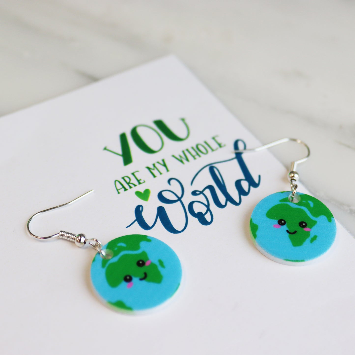 You are my whole world fun kawaii based earth earrings shown in white background