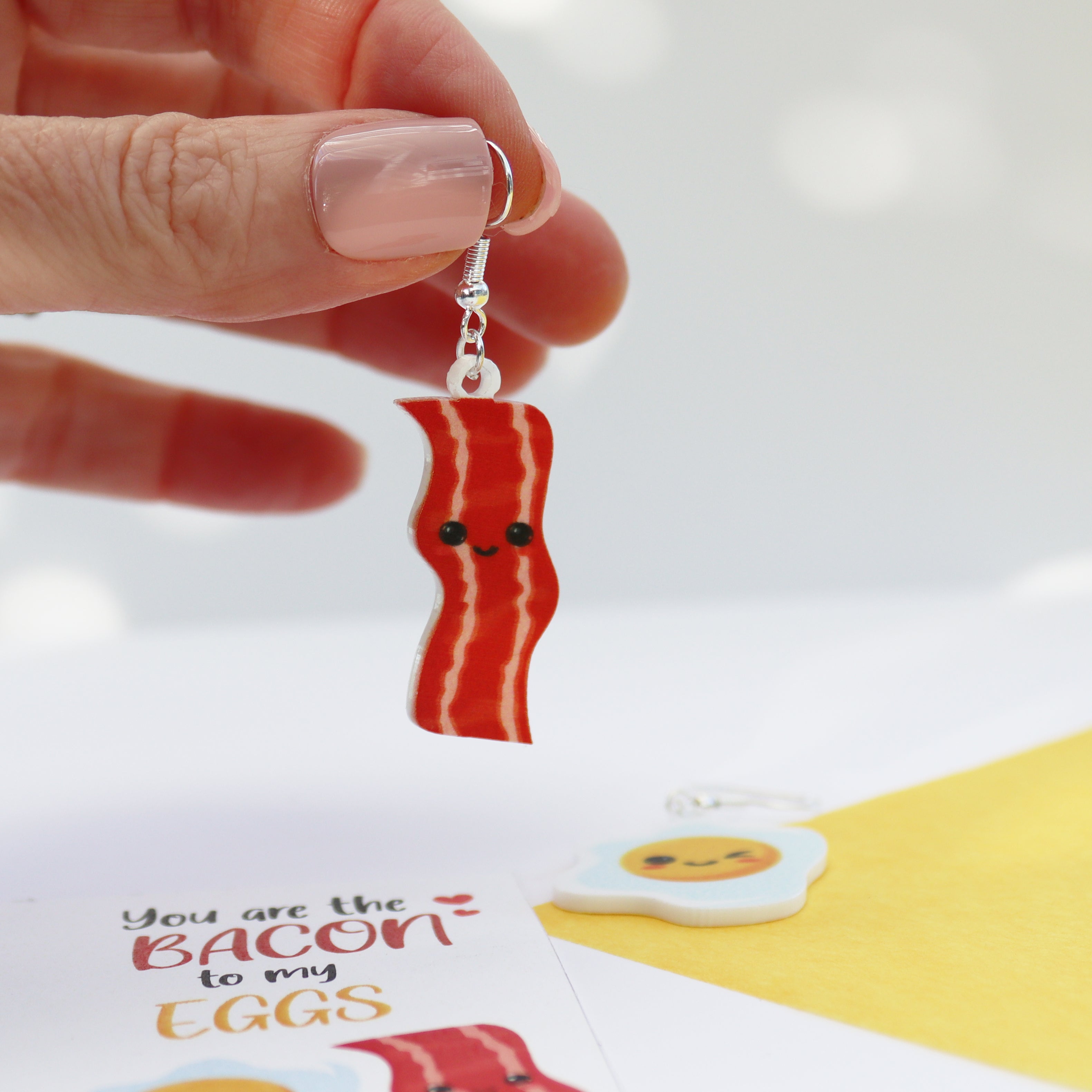 acrylic bacon to my egg acrylic printed earrrings valentine's day earrings funny valentines earrings shown bacon being held