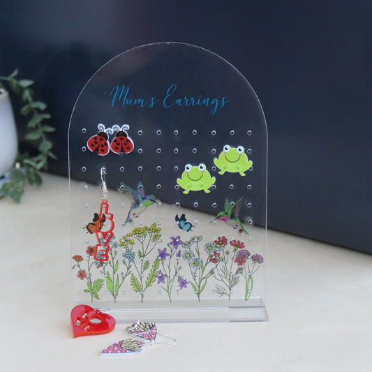 acrylic earring holder with a wild flower patterned printed onto the acrylic personalised with name