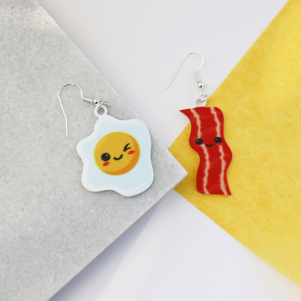 bacon to my eggs earrings shown on a piece of marble