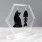 black cat and fish bone mismatches earrings cut from black acrylic shown hanging on earring display holder
