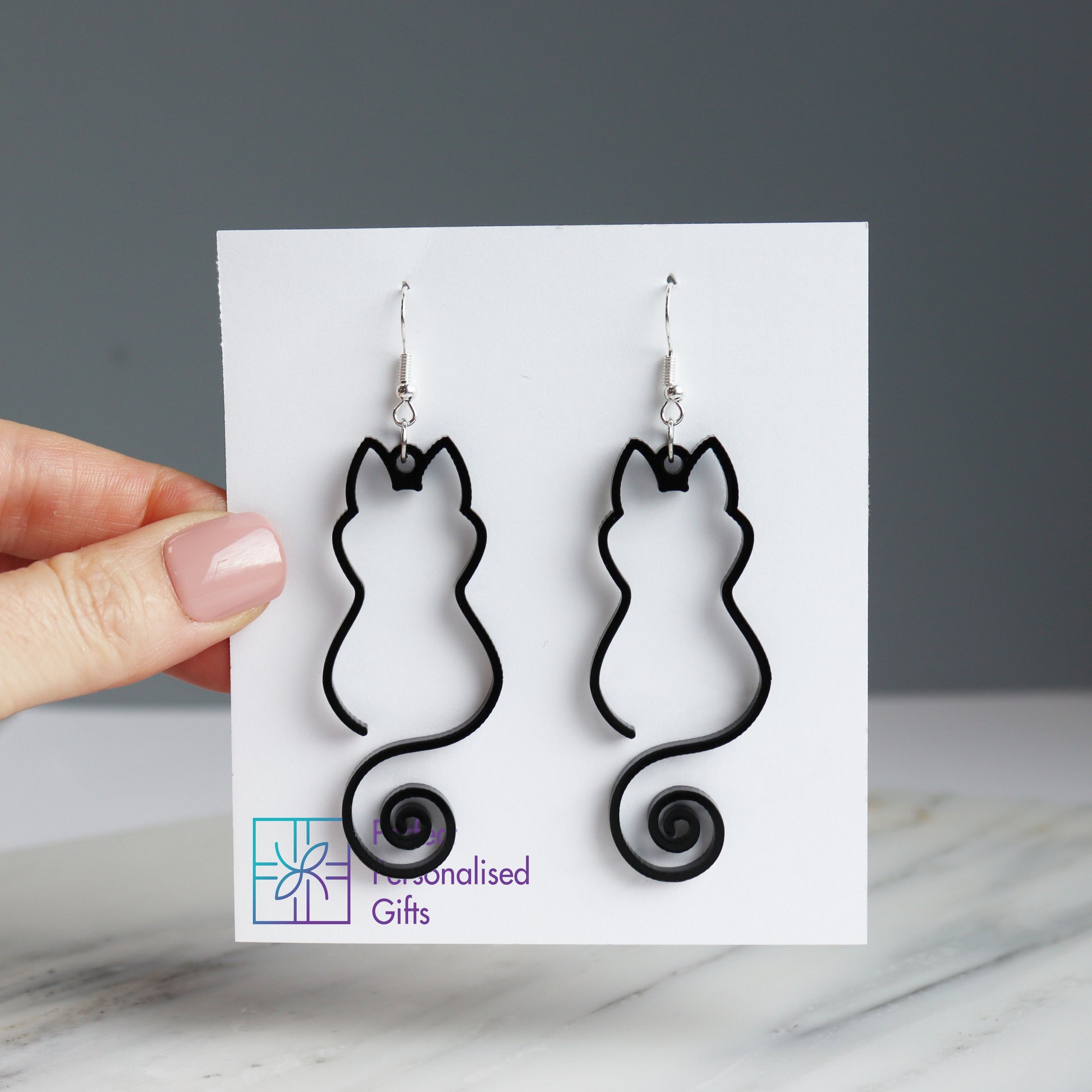 black cat outline pair of earrings acrylic outline cat earrings close up