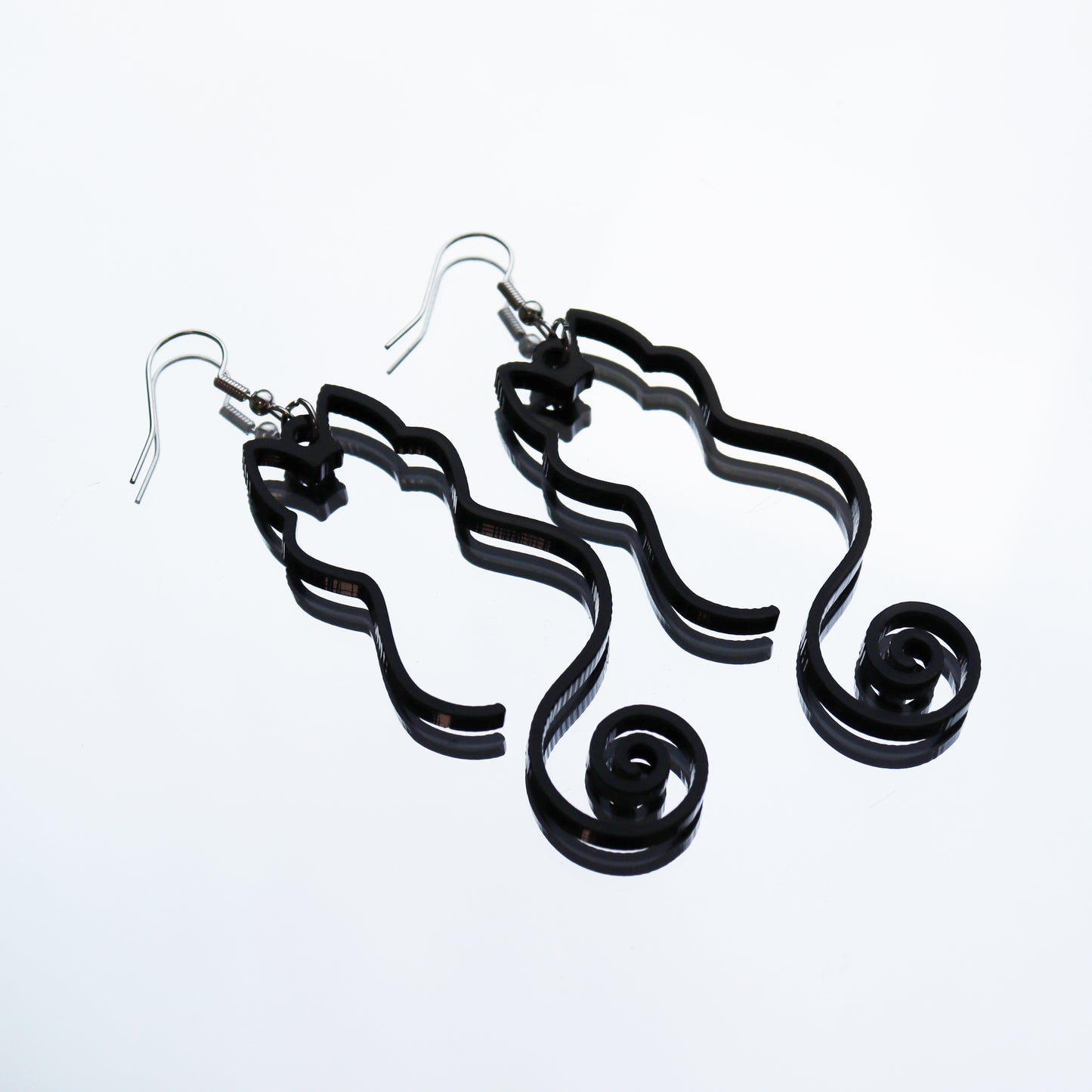 black cat silhouette large hanging black acrylc statement earrings perfect for halloween shown on mirror backing