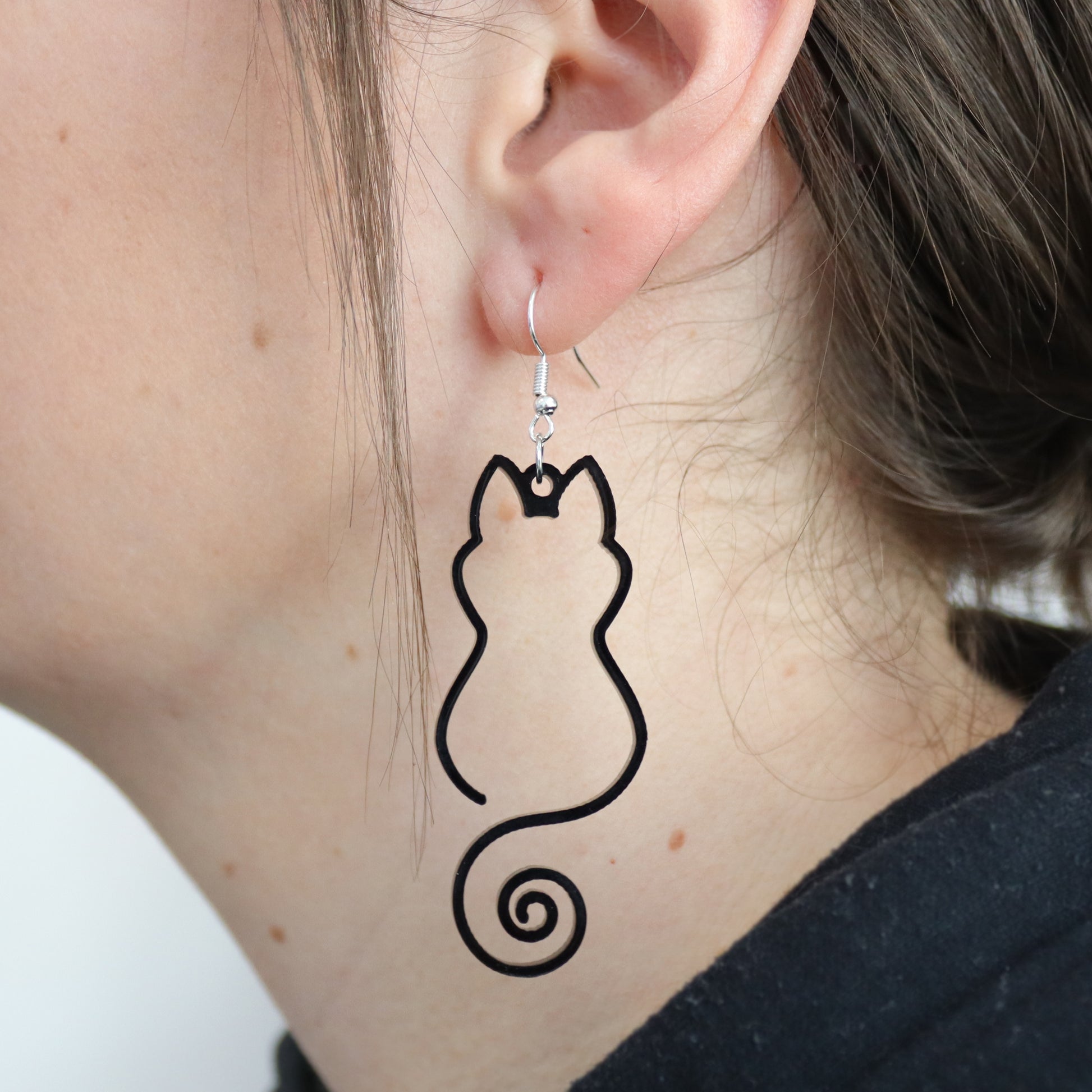black cat silhouette large hanging black acrylic earring shown hanging in ear