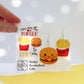 close up of burger earrings for burger and fries earrings hand held burger with a white backing card