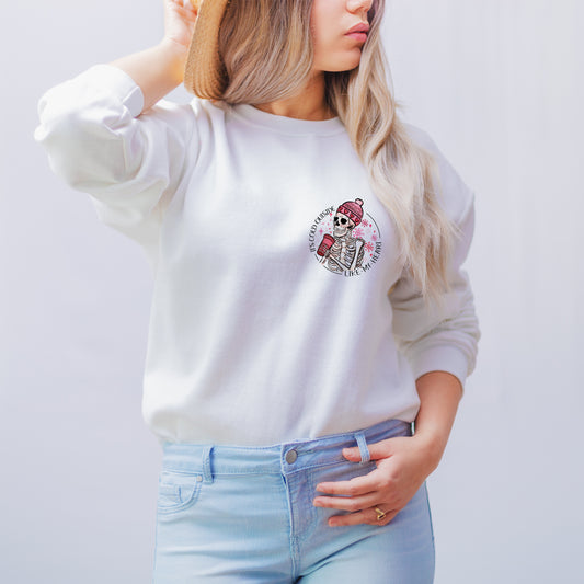 Vegan white sweatshirt with anti Valentine's day design cold like my heart skull print paired with jeans and trainers