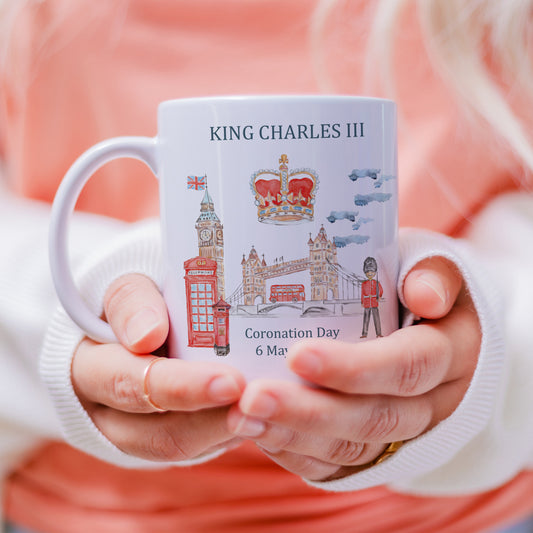commemorative Kings Coronation white mug with painted London scene and crown for King Charles III coronation