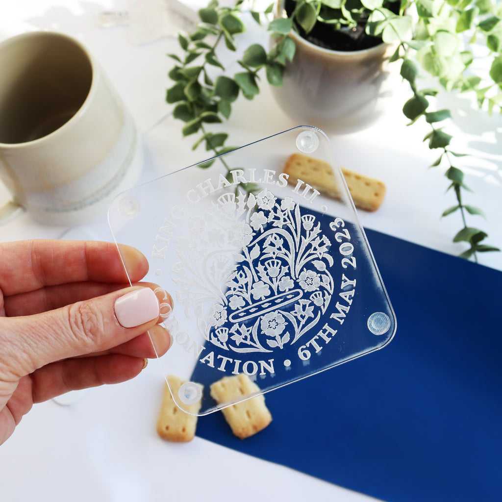 engrved acrylic coronation coaster held in hand