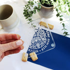 engrved acrylic coronation coaster held in hand