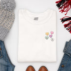 Women's Valentine's sweatshirt with love hearts sweets design paired with Jeans