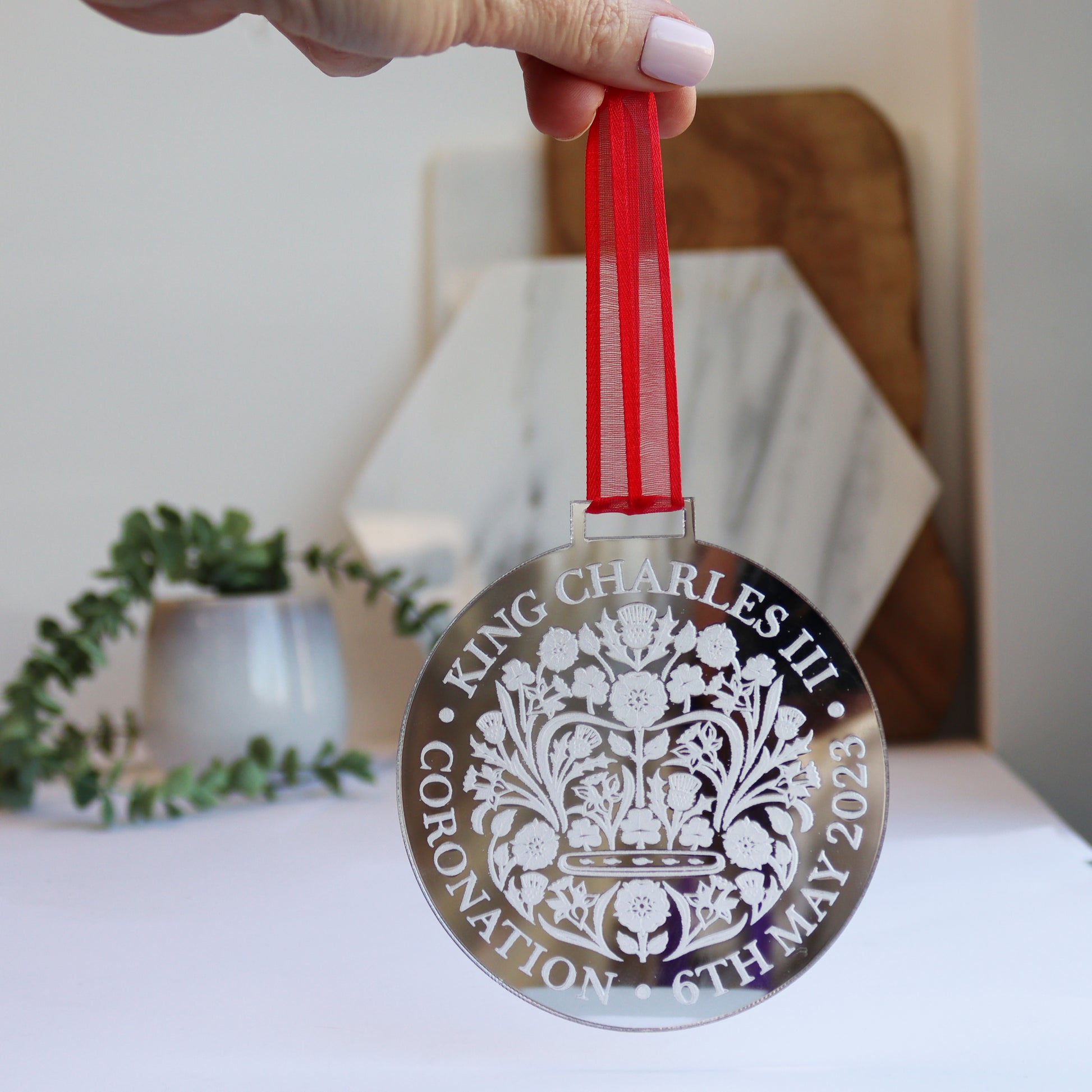 hanging silver medal for coronation with keepsake card