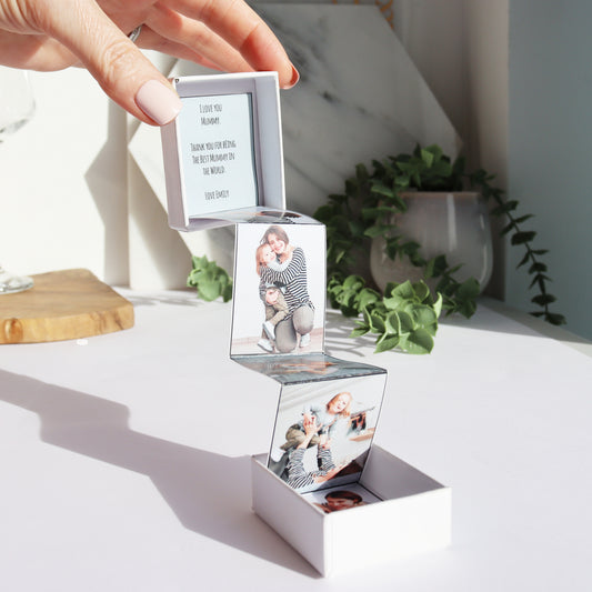image of personalised photo pop out box shown being help apart by a hand