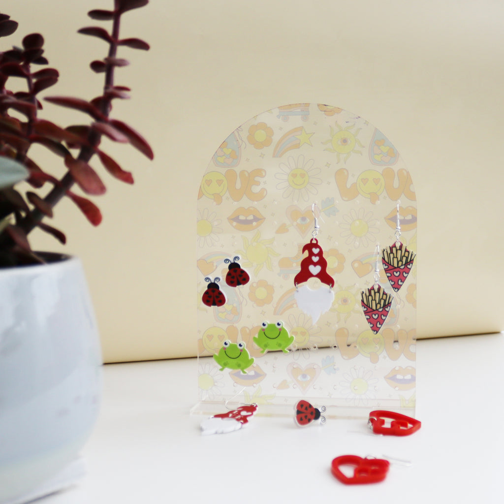 pretty acrylic earring holder printed with a meadow scene and can be personalised image shows personalisation as Mum's earrings