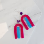 modern bright and colourful geometric arch dangle earrings cut from a purple, pink and turquoise acrylic