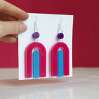 modern bright and colourful geometric arch dangle earrings cut from a purple, pink and turquoise acrylic