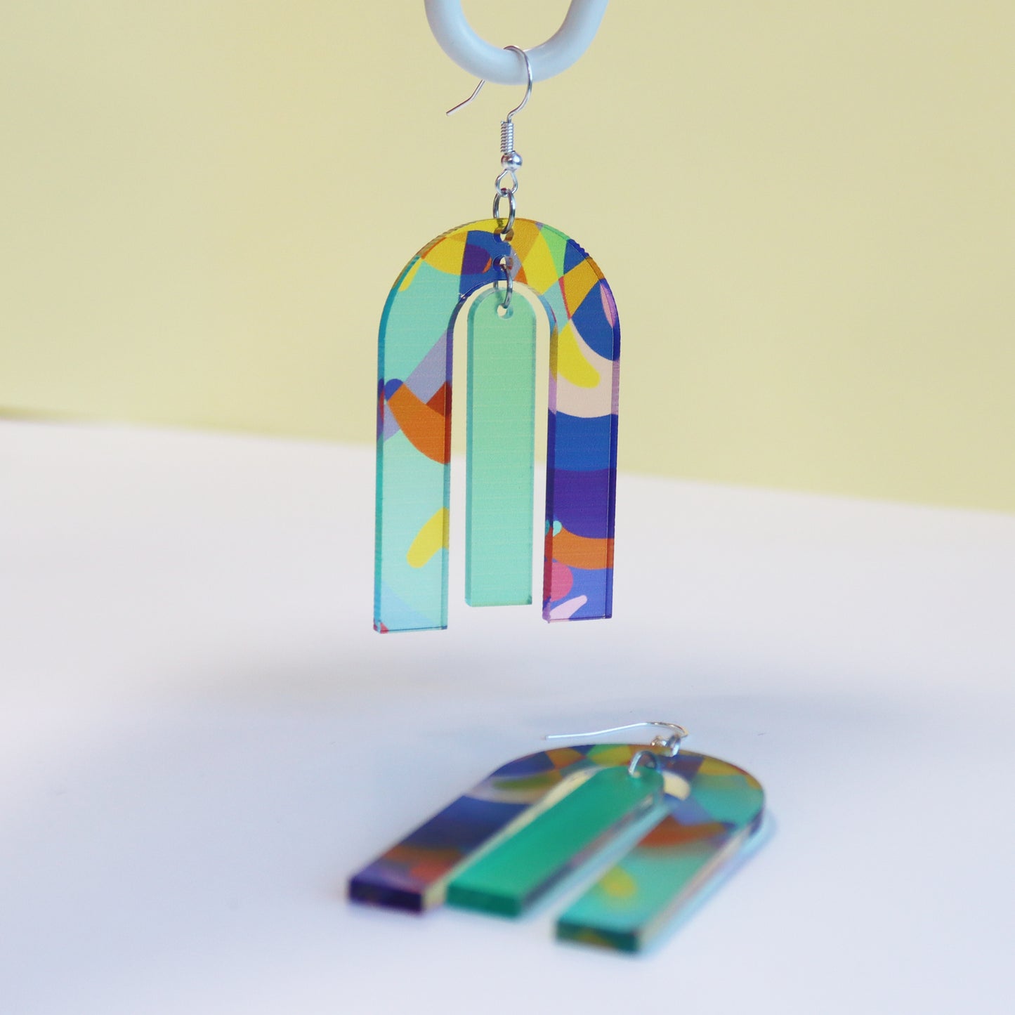 modern large arch shape geometric shape printed acrylic statement earrings shown hanging fun pritned earrings