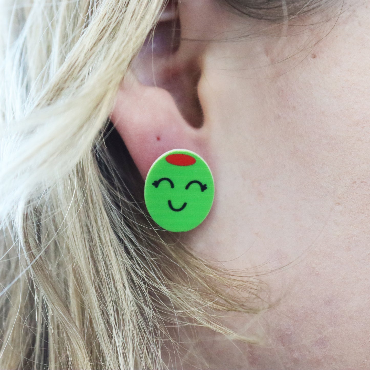 olive stud earring shown in ear