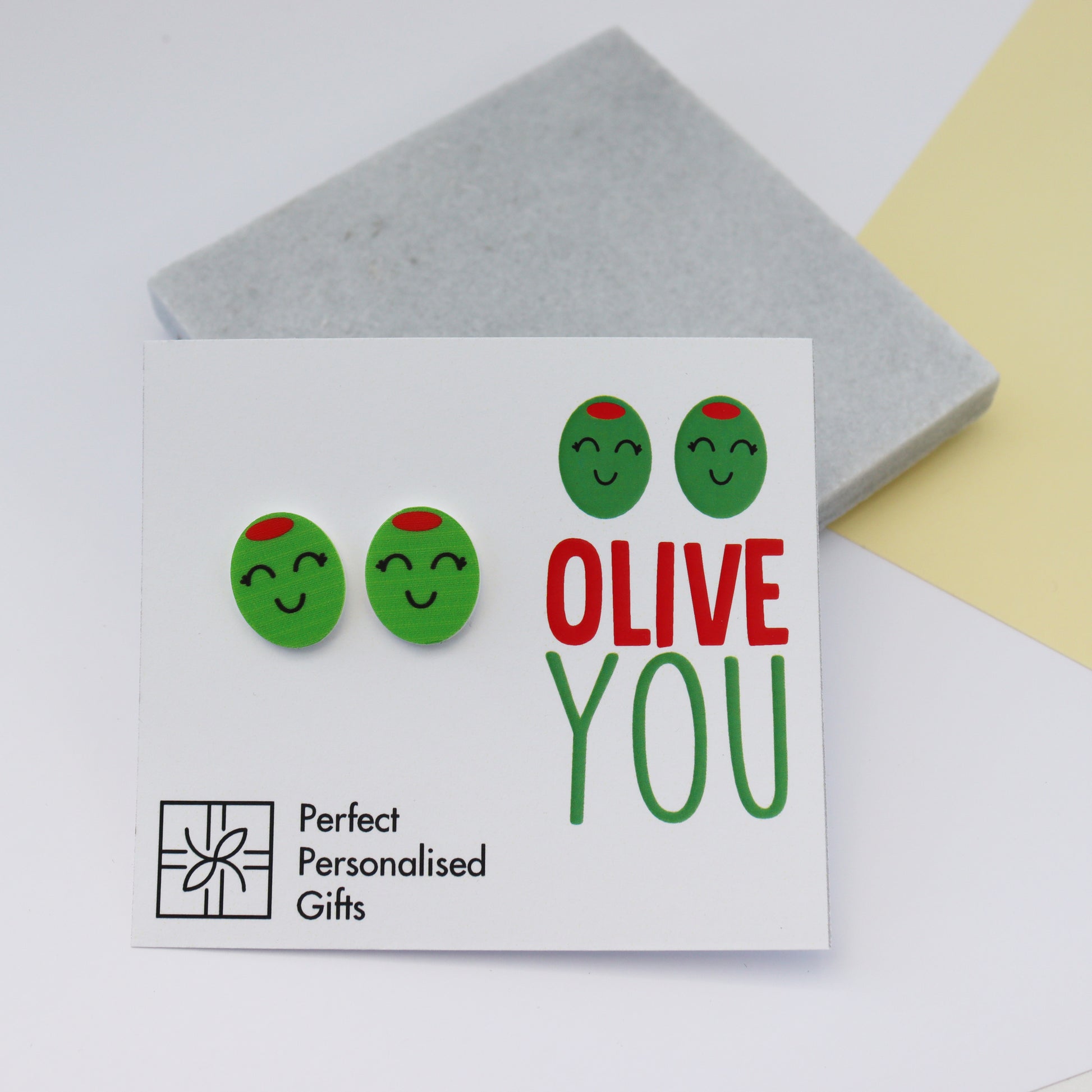 olive you stud olive earrings on white backing with print Olive You
