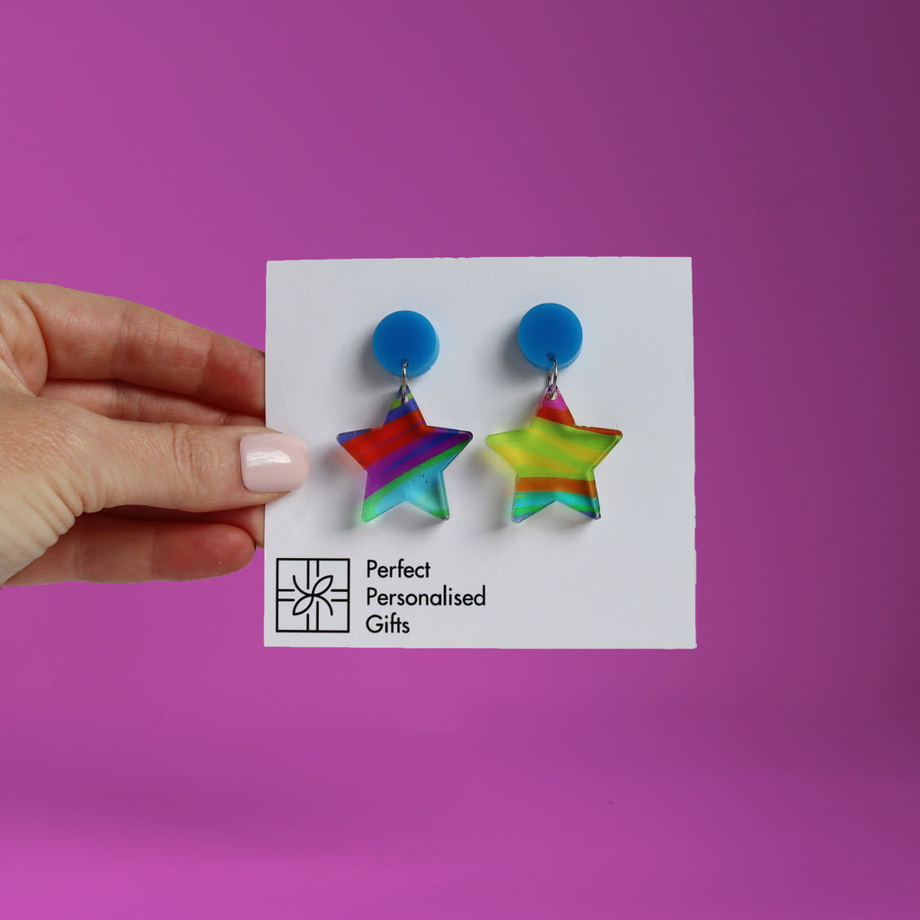 printed acrylic colourful handmade acrylic earrings on a pink background