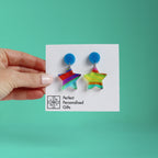 printed acrylic colourful handmade acrylic earrings on a turquoise background