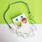 printed star acrylic clear necklace statement fashion jewellery on white and green background with matching earrings