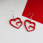 red laser cut acrylic heart swirl earrings which are made on silver plated hypoallergenic hook earring backings