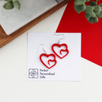 simple but bold red acrylic swirl heart earrings which are shown on the earring backed card and brand name Perfect Personalised Gifts