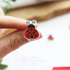 Small coloured stud earring with ladybird design