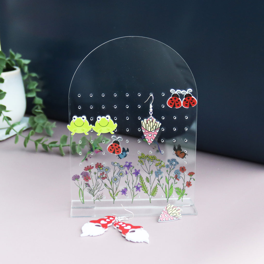acrylic earring holder with a wild flower patterned printed onto the acrylic personalised with name
