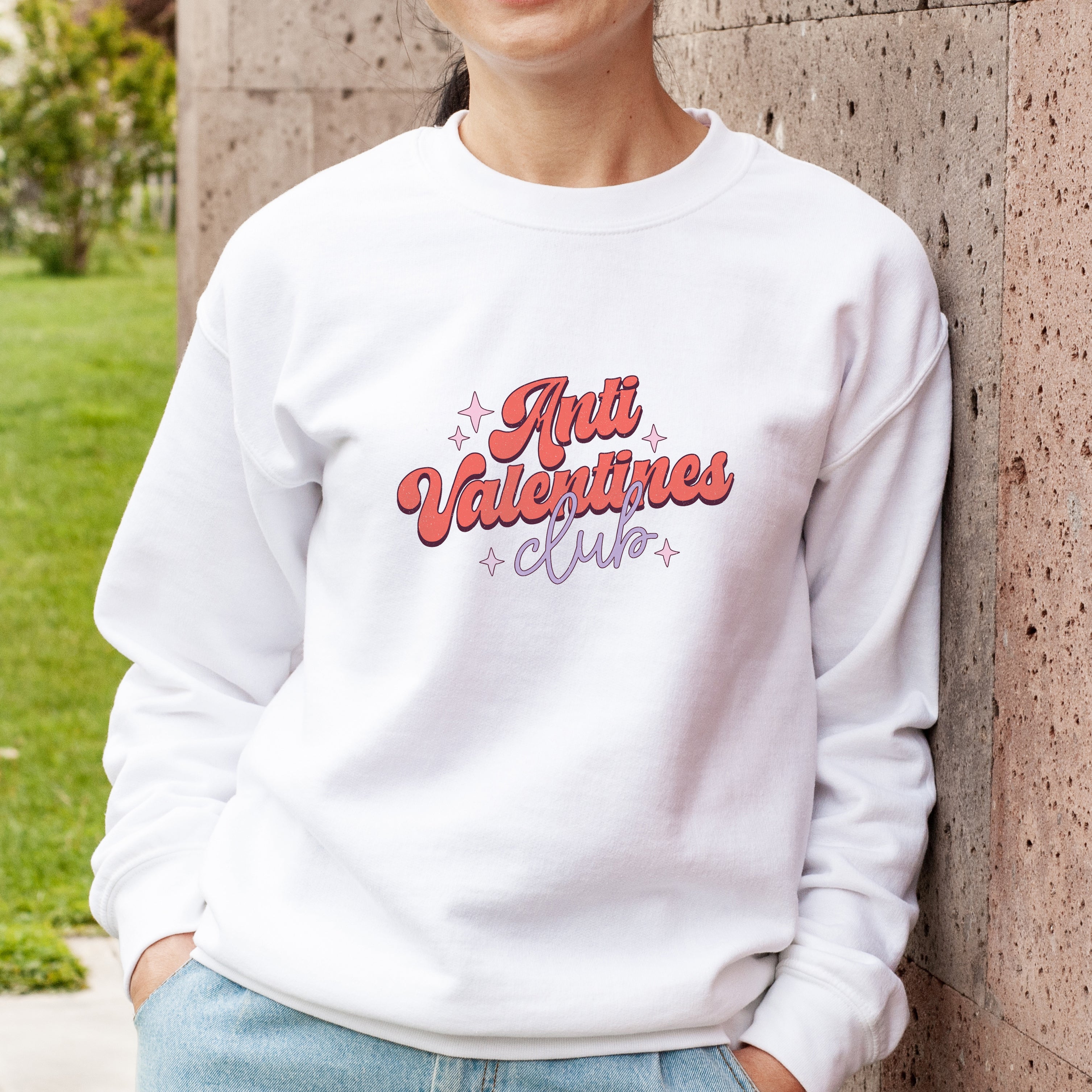 Anti Valentine's white jumper with retro print modelled with jeans