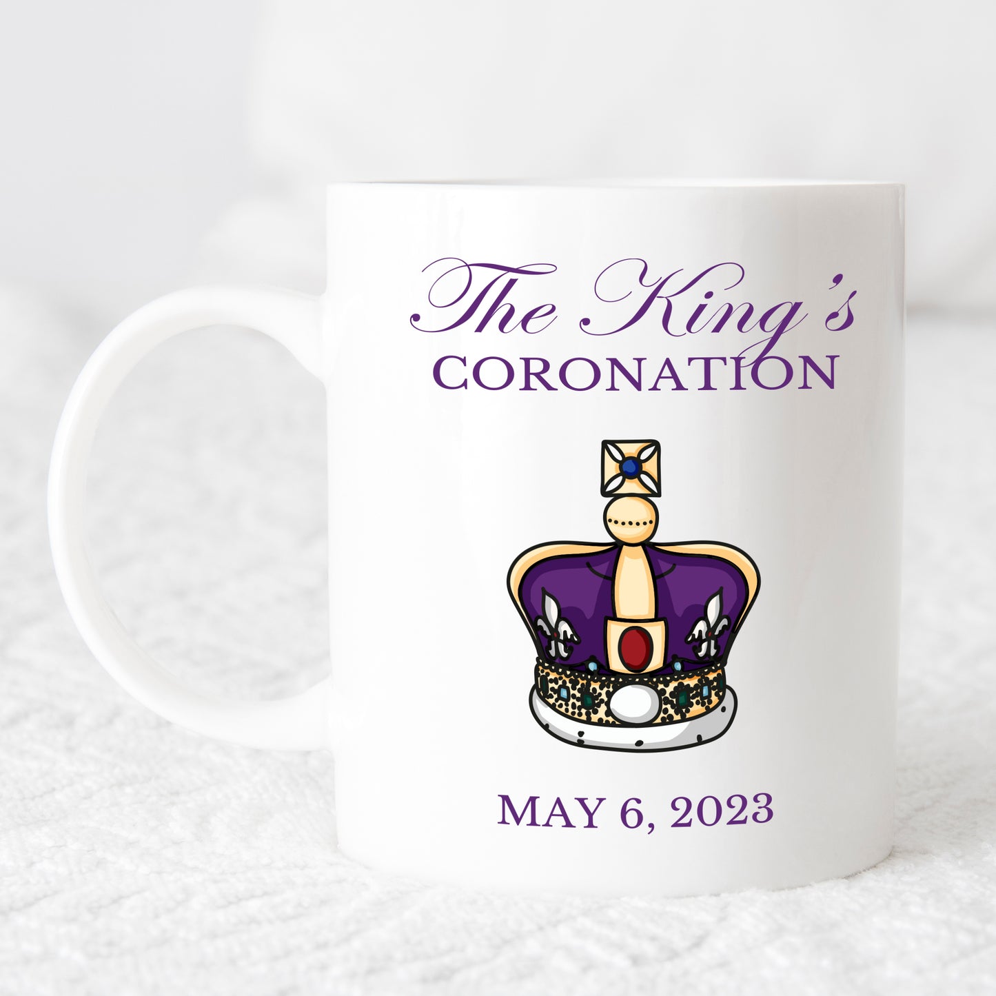 white mug printed withkings coronation in purple with royal crown and date 6 May 2023