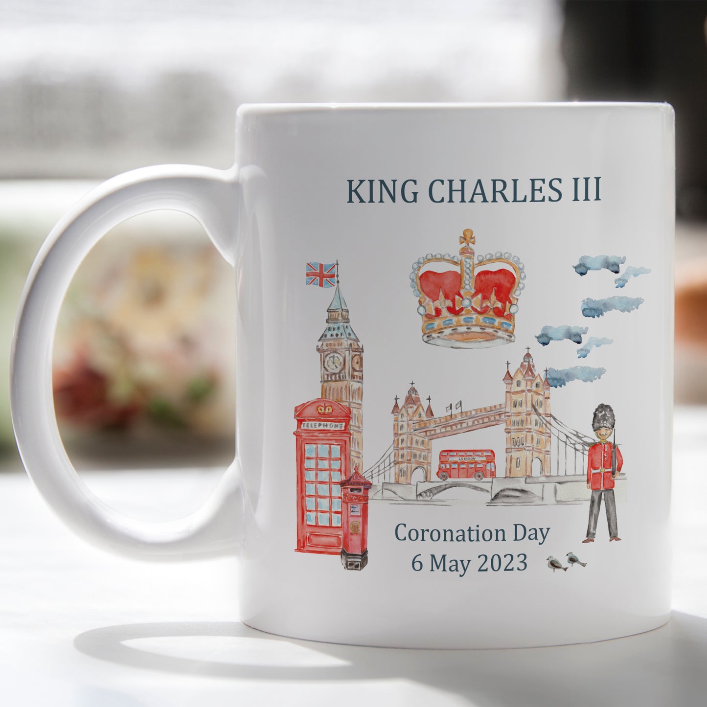 white mug printed with watercolour London scene with the Kings Coronation crown shoe with the words King Charles III 6 May 2023 Coronation